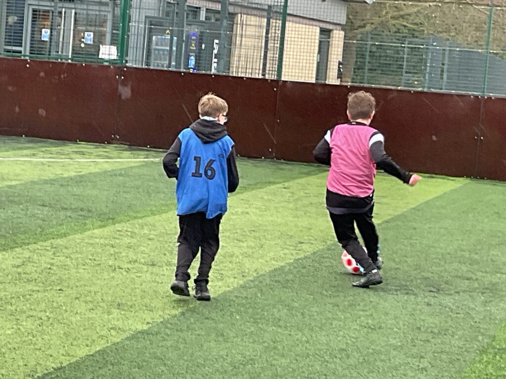 Milestone students playing football