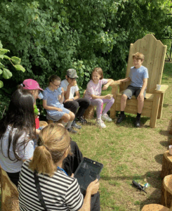Pupils and a teacher sitting in the fairy circle