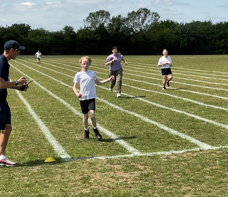 Young children taking part in a running race at sports day