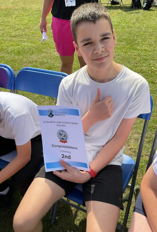 A pupil with a sports day certificate