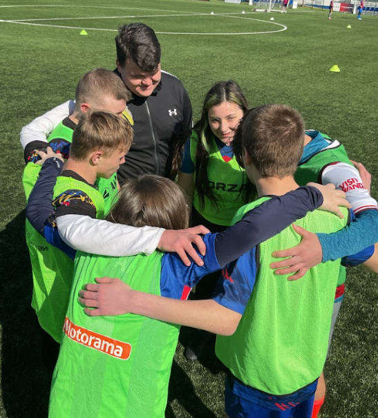 A young football team in a group huddle