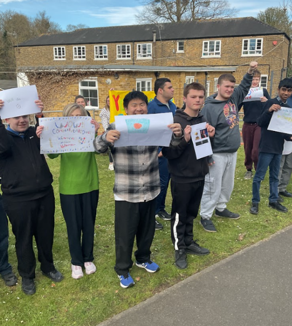 Children and adults showing support for a football team with banners