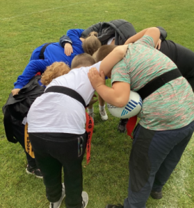 tag rugby team in a huddle